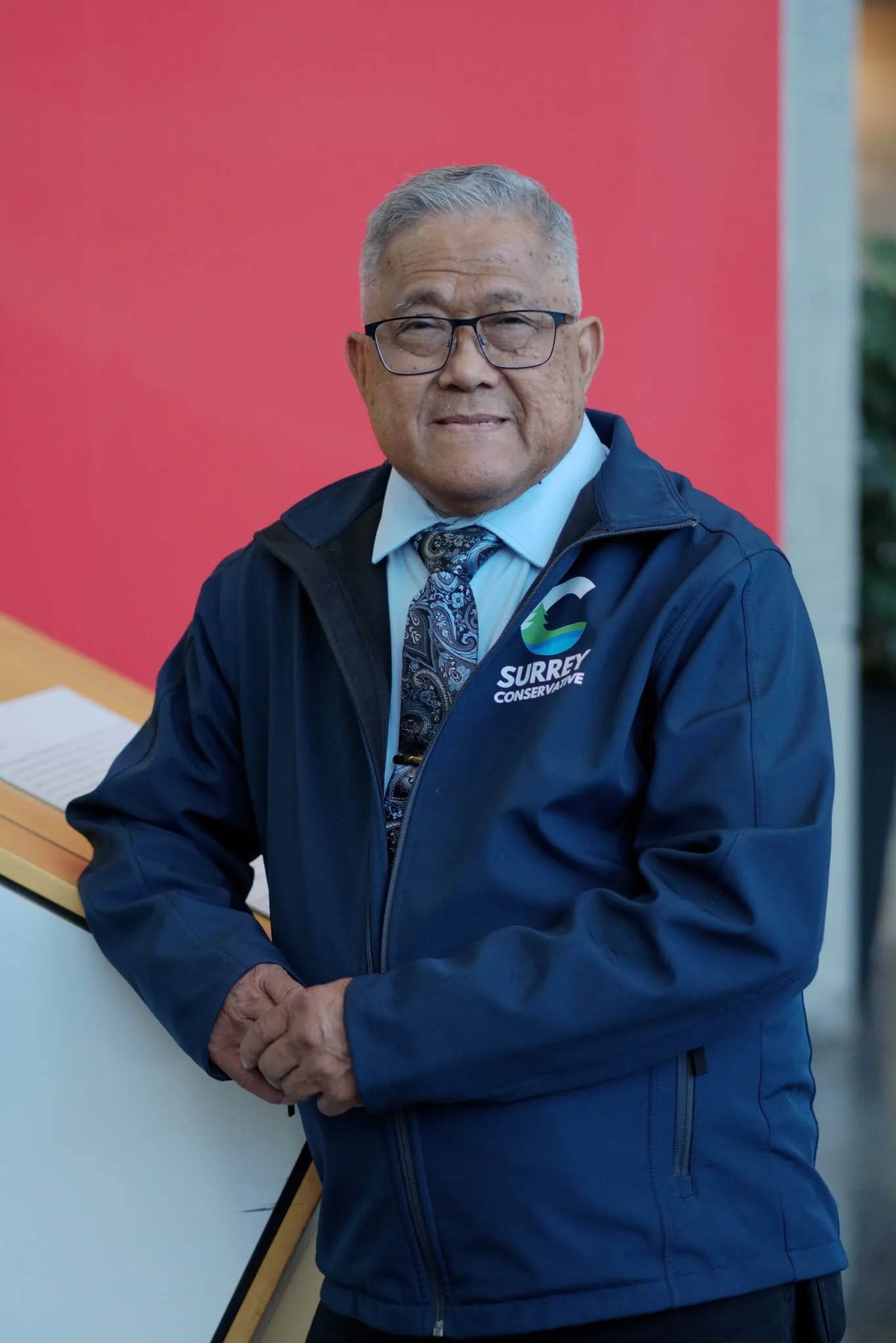 Dan B. Carlos, candidate for Surrey City Council, wearing a Surrey Conservative jacket